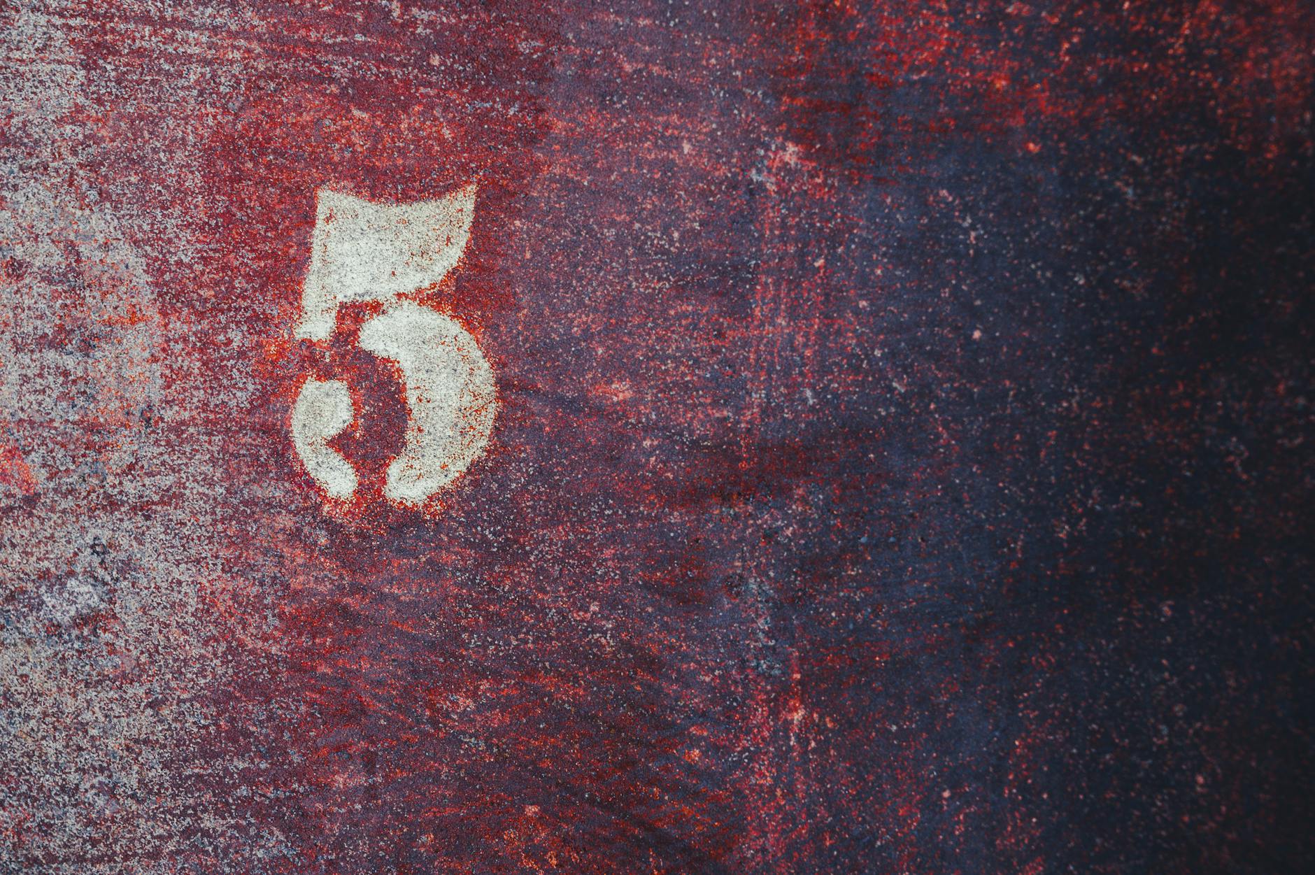 close up photo of a number on a rusty surface